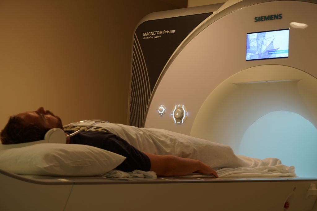 A PATIENT GOING INTO AN MRI MACHINE.